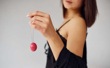 Woman in black sexy clothes shows vaginal balls and imbuilding tools in the room.の写真素材