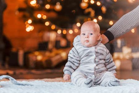 Mother with her child together in christmas decorated room.の写真素材