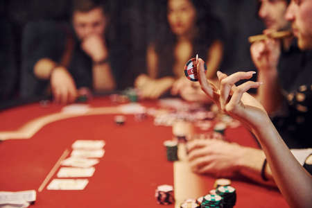Group of elegant young people that playing poker in casino together.の写真素材
