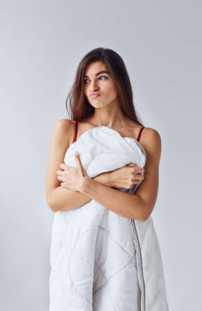 Woman in underwear in the studio against white background.の写真素材