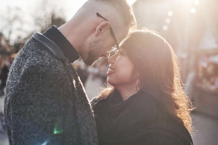Beautiful sunlight. Happy multiracial couple together outdoors in the city.の写真素材