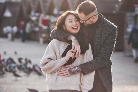 Asian girl with her caucasian boyfriend have fun outdoors in the city.の写真素材