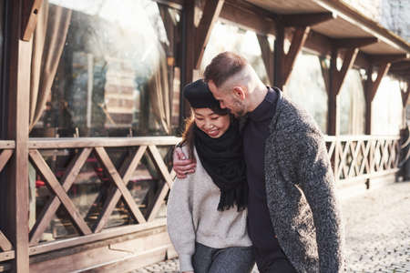 Lovely multiracial couple have a walk in the city and embracing each other.の写真素材