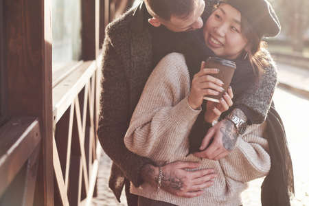Playful and lovely multiracial couple together outdoors in the city. Asian girl with her caucasian boyfriend.の写真素材