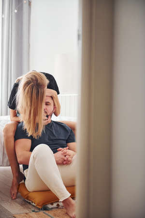 Young married couple have leisure together in bedroom at daytime.の写真素材