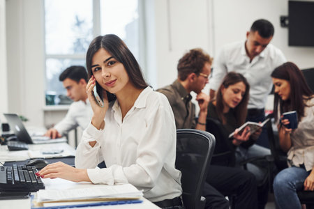 Woman have a call. Young business people working together in the modern office.