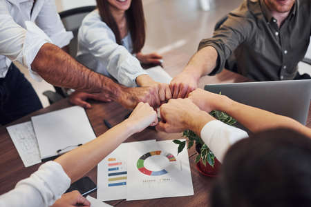 Close up view of business people that celebrating success in the modern office.の写真素材