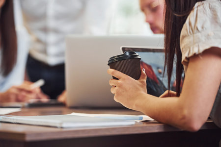 Close up view of business people that sitting and working together in the modern office.