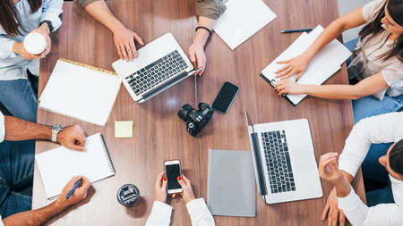 Top view of young business people that working together with documents and laptop in the modern office.の写真素材