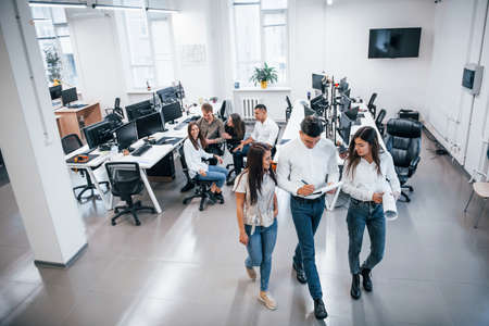Group of young business people that standing and sitting and working in the office.の写真素材