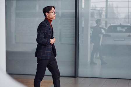Young business man in luxury suit and formal clothes is indoors in the office.の写真素材
