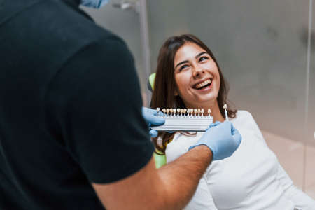 Cheerful woman have a visit in the dentist clinic. Conception of stomatology.の写真素材