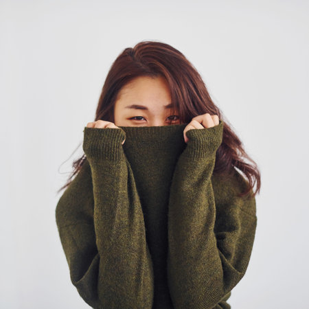 Portrait of happy asian young girl that standing indoors in the studio against white background.