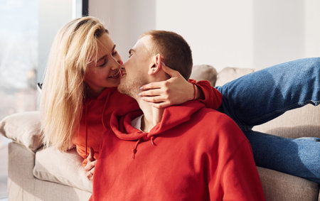 Closeness of people. Young lovely couple together at home spending weekend and holidays together.