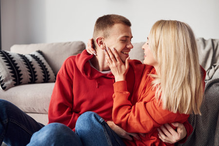 Closeness of people. Young lovely couple together at home spending weekend and holidays together.