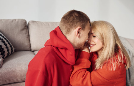 Closeness of people. Young lovely couple together at home spending weekend and holidays together.