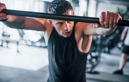 Strong young man in sportive clothes have fitness day in the gym. Taking a break.の写真素材