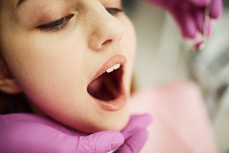 Little girl visiting dentist in clinic. Conception of stomatology.