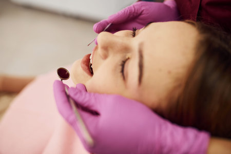 Little girl visiting dentist in clinic. Conception of stomatology.