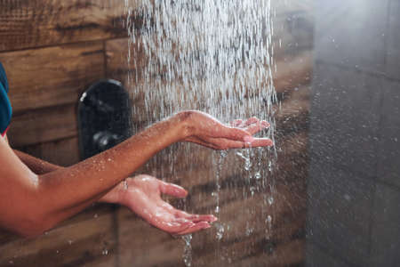 Close up view of hands of woman that taking a shower.の写真素材