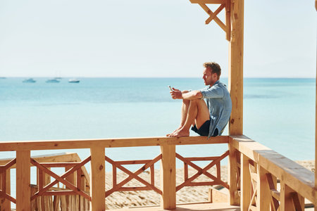 Young european man have vacation and enjoying free time on the beach of seaの写真素材