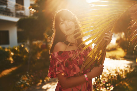 Happy mature woman is outdoors enjoying her vacation at sunny daytimeの写真素材