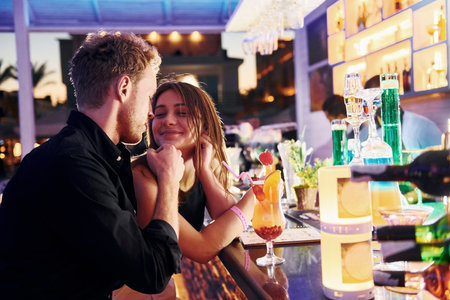 At the bar. Happy young couple is together on their vacationの写真素材