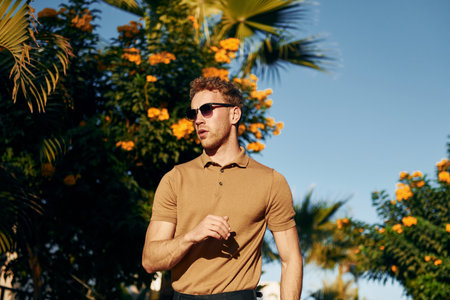 In sunglasses. Young man is outdoors at sunny daytime. Concept of vacationの写真素材