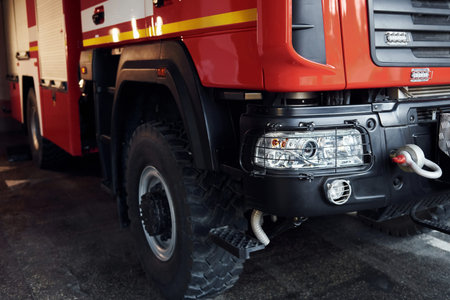 Close up view of front part of red fire truck. Natural lighting