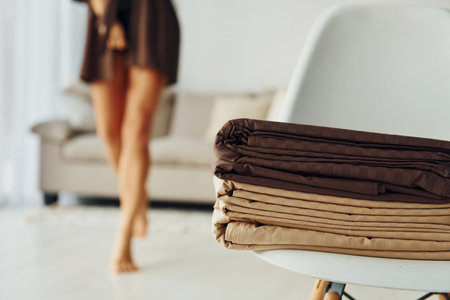 Blur view of woman near bed clothes. Interior and design of beautiful modern bedroom at daytimeの写真素材