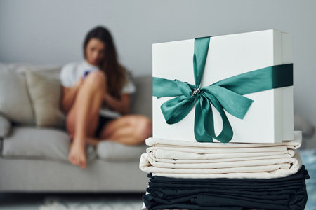 Cheerful girl is on the bed. Interior and design of beautiful modern bedroom at daytimeの写真素材