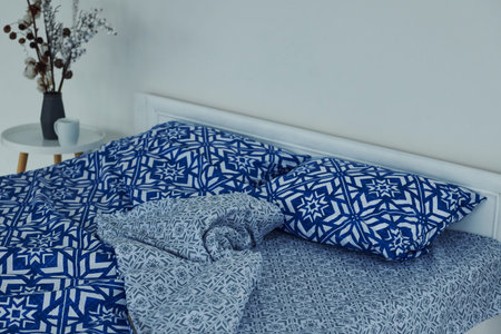 Blue colored bed. Interior and design of beautiful modern bedroom at daytime