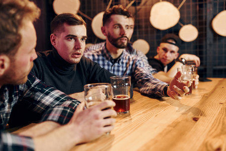 Group of people together indoors in the pub have fun at weekend timeの写真素材