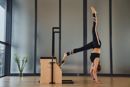Young woman in sportive wear and with slim body have fitness yoga day indoorsの写真素材