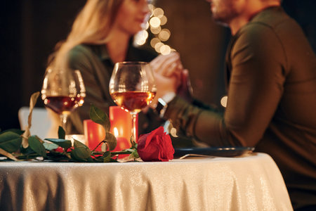 Closeness of the people. Young lovely couple have romantic dinner indoors togetherの写真素材