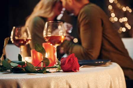 Closeness of the people. Young lovely couple have romantic dinner indoors togetherの写真素材
