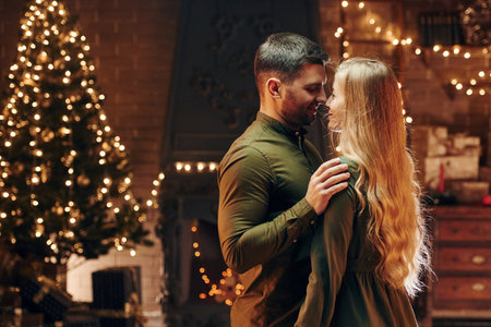 Standing and dancing. Young lovely couple have romantic dinner indoors togetherの写真素材