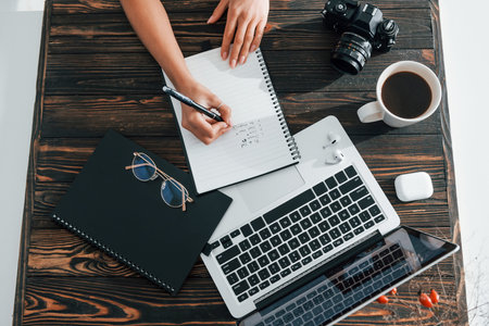 Young female freelancer working indoors in the office at daytime