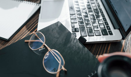 Close up view of young female freelancer that working indoors in the office at daytime