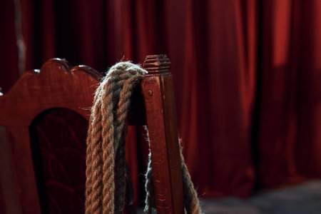 Close up view of knot that hanging on the red chair on the stage of theater