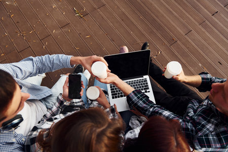 Top view of group of young cheerful friends that is outdoors having fun togetherの写真素材