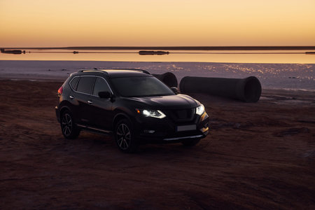 Distant view of modern black automobile that is on the coast