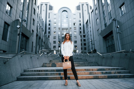 Beautiful young european woman is outdoors in the city at daytimeの写真素材