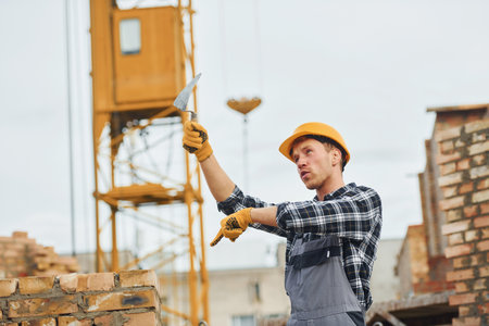 Construction worker in uniform and safety equipment have job on buildingの写真素材
