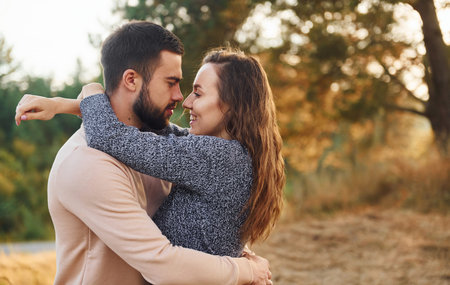 Closeness of the people. Cheerful lovely young couple having a rest outdoors togetherの写真素材