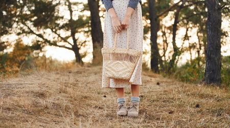 Young woman have a walk outdoors in the forest at sunny daytimeの写真素材