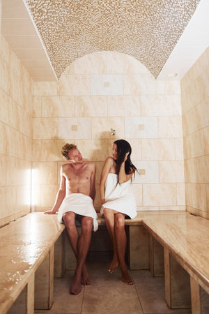 Happy couple together in sauna. Conception of vacation and weekendの写真素材