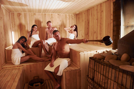 Group of young people together in sauna. Conception of vacation and weekendの写真素材