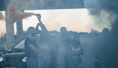 Using smoke. Group of protesting young people that standing together. Activist for human rights or against governmentの写真素材