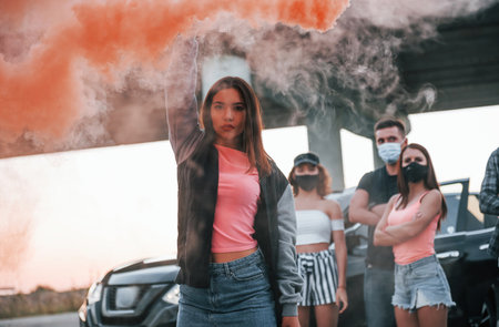 Using smoke. Group of protesting young people that standing together. Activist for human rights or against governmentの写真素材